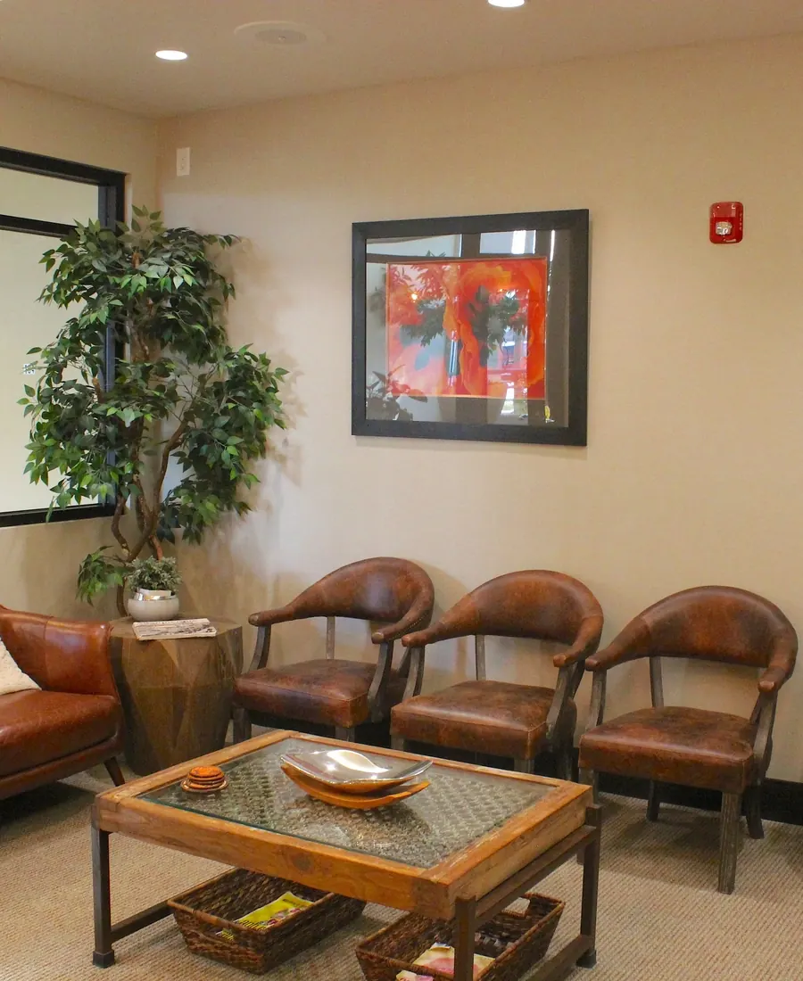 Leather armchairs and a coffee table in the waiting room at Dr. Slaman & Associates.