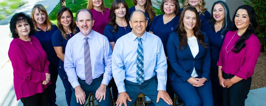 The Dr. Slaman & Associates team together outside the office.